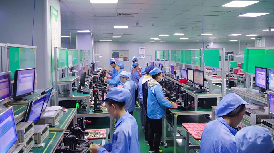 Electronics assembly line with workers performing PCBA quality control and inspection in factory